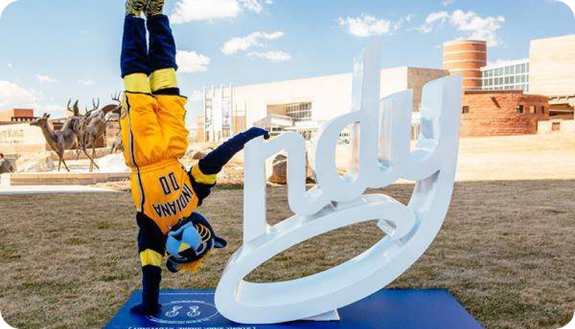 Boomer the mascot doing a handstand next to the 